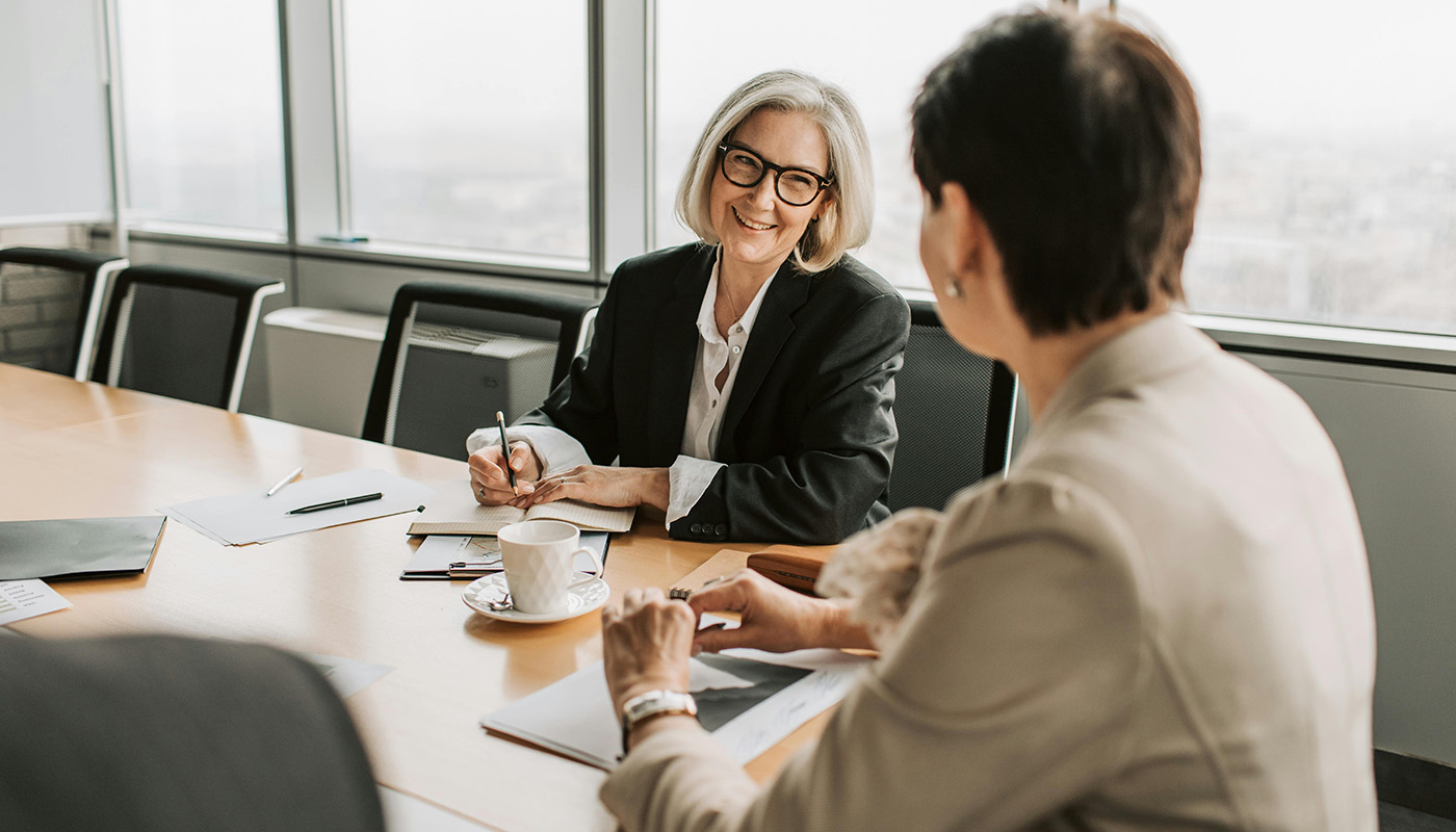 Two women meeting over coffee.