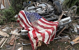 An image showing an American flag laying on a broken down car.