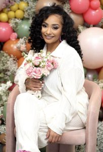 A person sitting in a chair holding a bouquet of flowers.